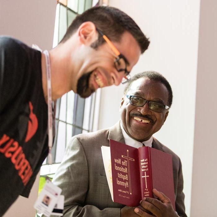 LTSS professor and student share a laugh during a conversation